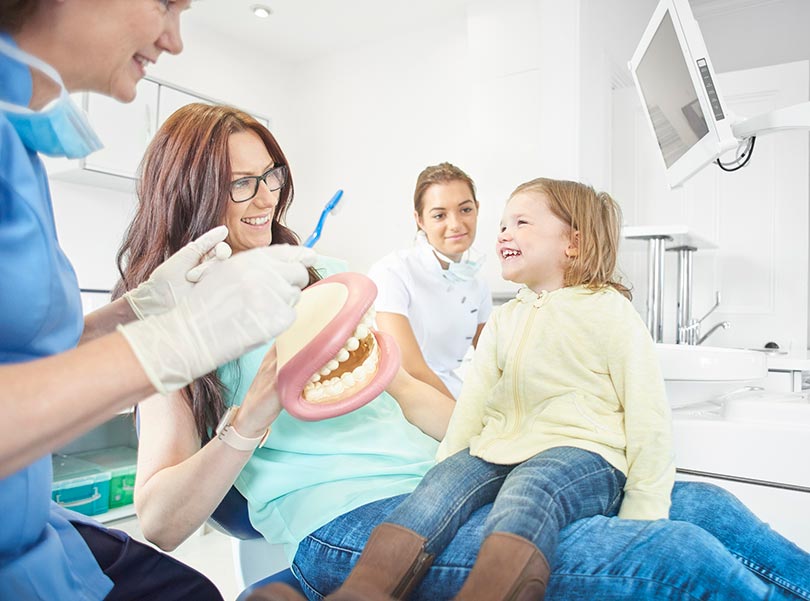 Kid is learning oral hygiene in dentistry