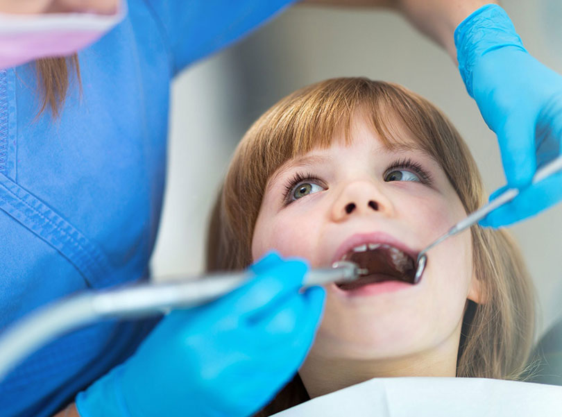 dentist filling kid`s tooth